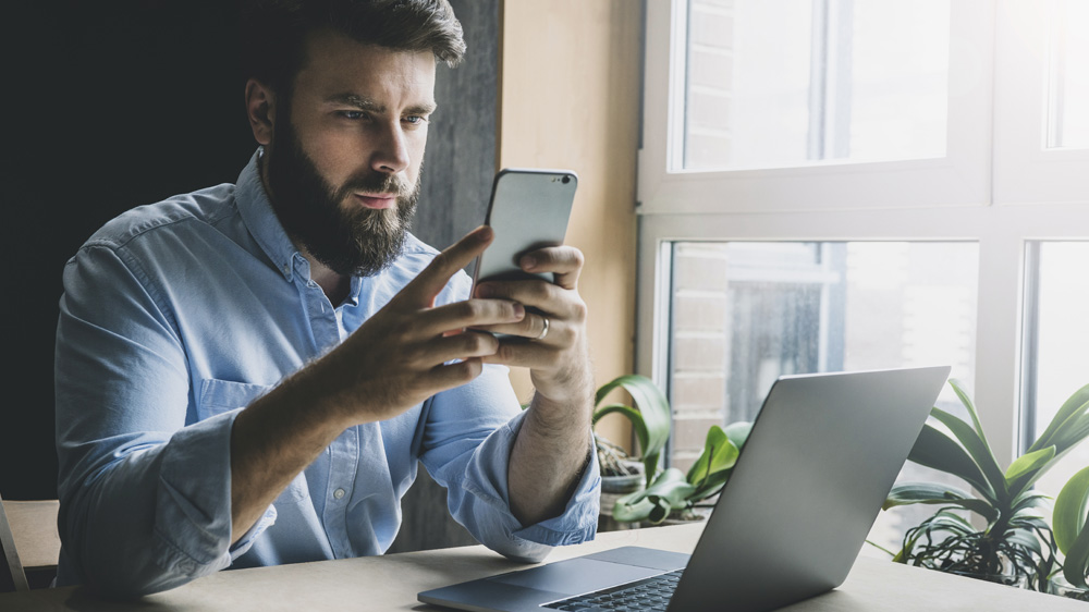 Business Man working on computer and mobile phone