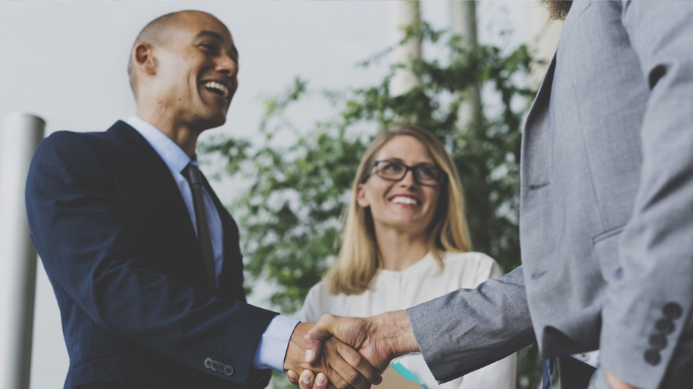 man and woman creating a business deal